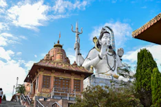 a statue of a god on top of a building