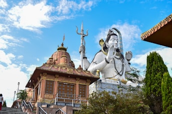 a statue of a god on top of a building