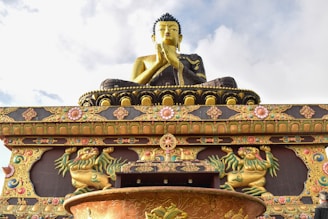 a statue of a buddha sitting on top of a fountain