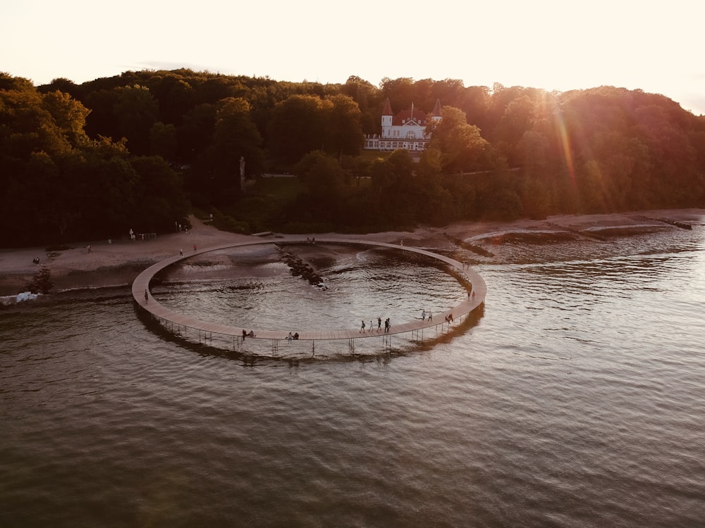 an aerial view of a circular bridge over a river