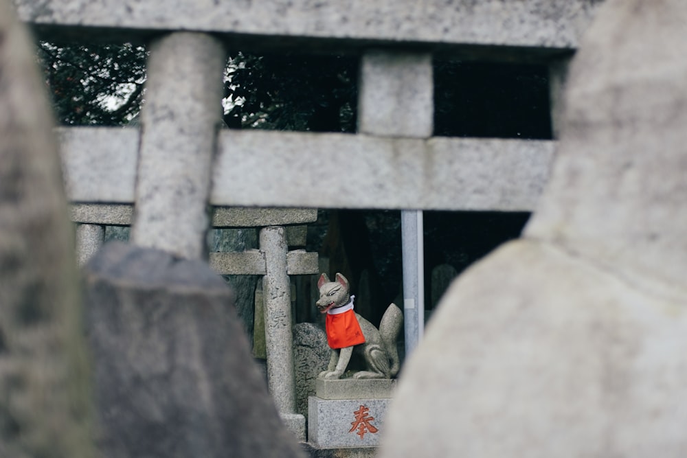 a statue of a dog wearing a red coat