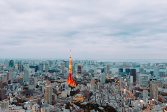 a view of a city with a red and yellow tower