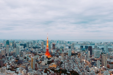 a view of a city with a red and yellow tower