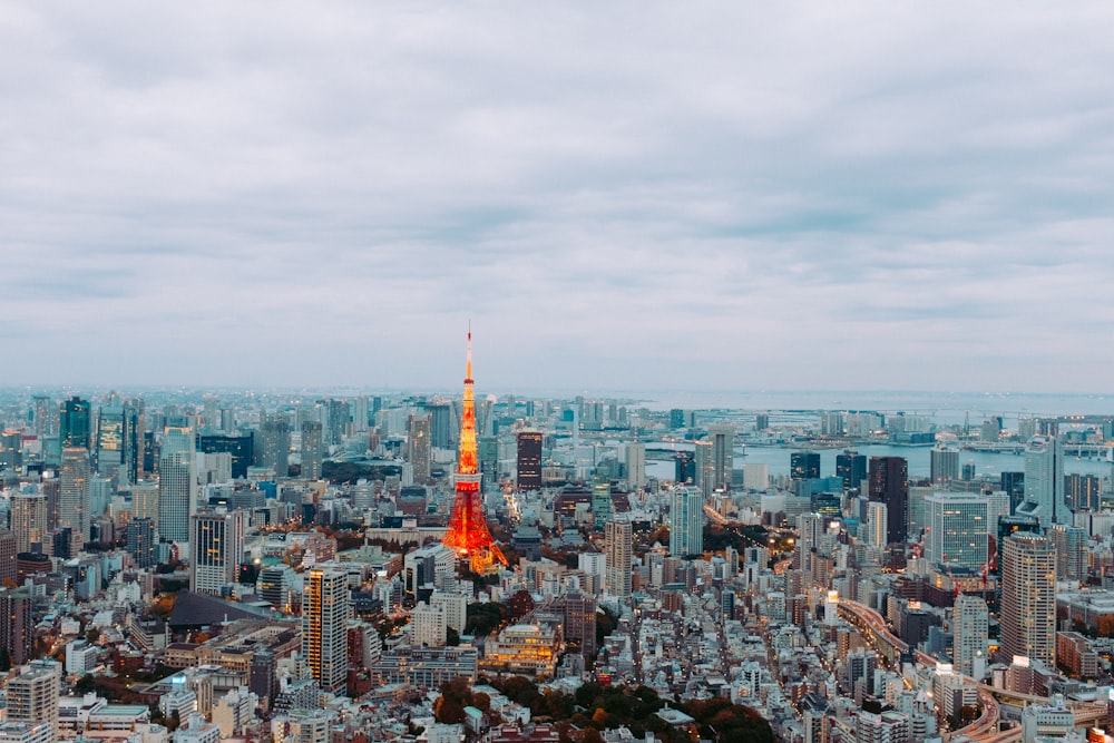 a view of a city with a red and yellow tower