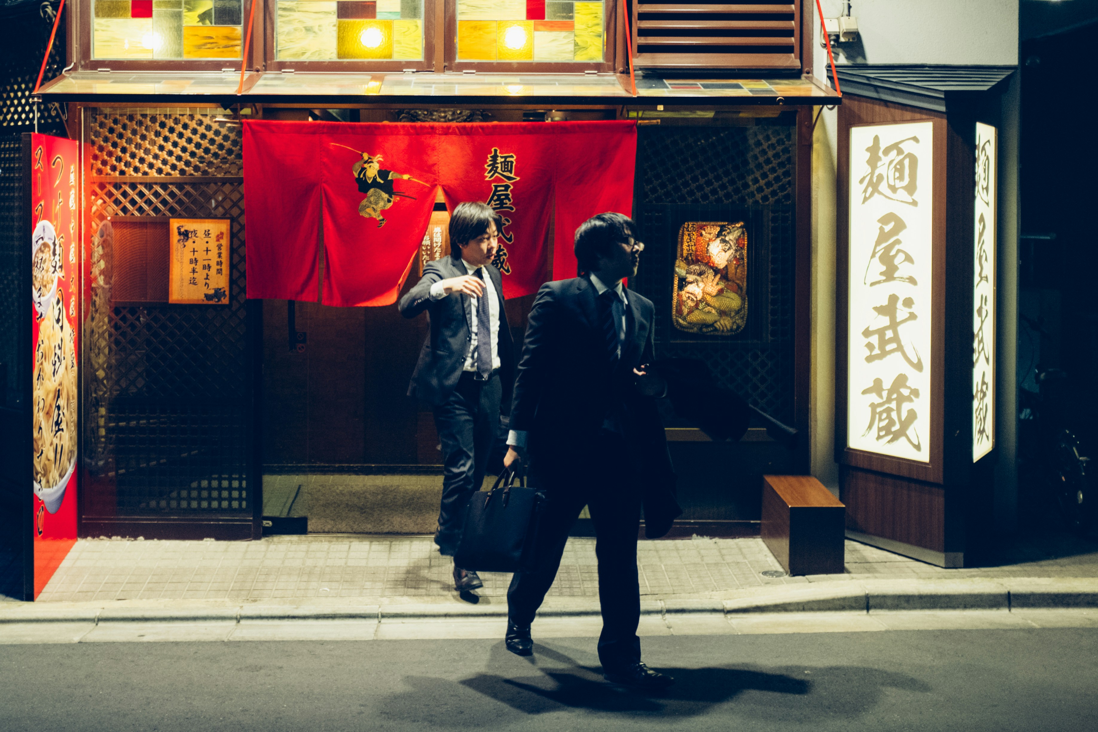 a couple of people that are standing in front of a building, 