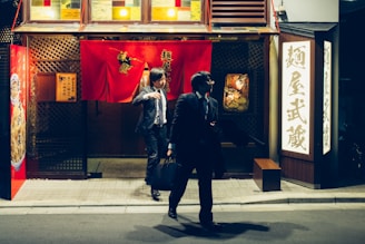 a couple of people that are standing in front of a building