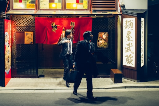 a couple of people that are standing in front of a building