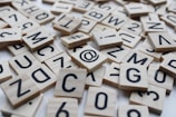 a pile of wooden scrabbles sitting on top of a table