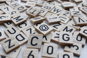 a pile of wooden scrabbles sitting on top of a table