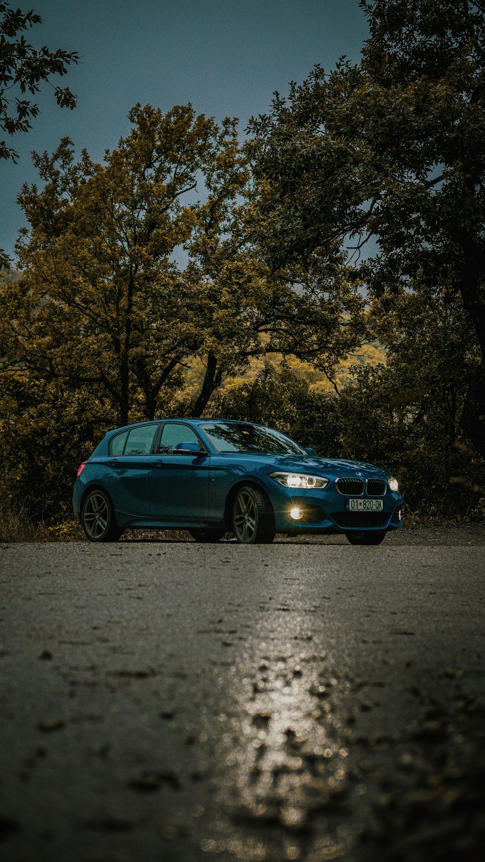 a blue car parked on the side of the road