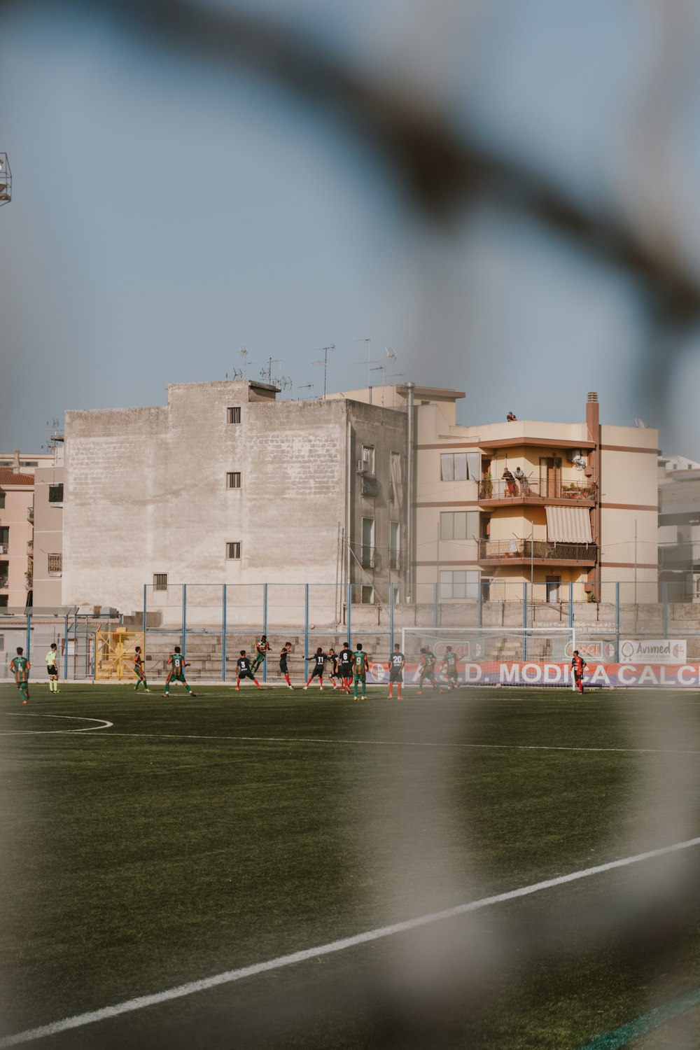 a soccer field with a building in the background