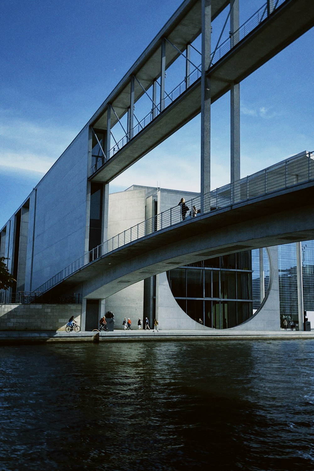 a bridge over a body of water next to a building