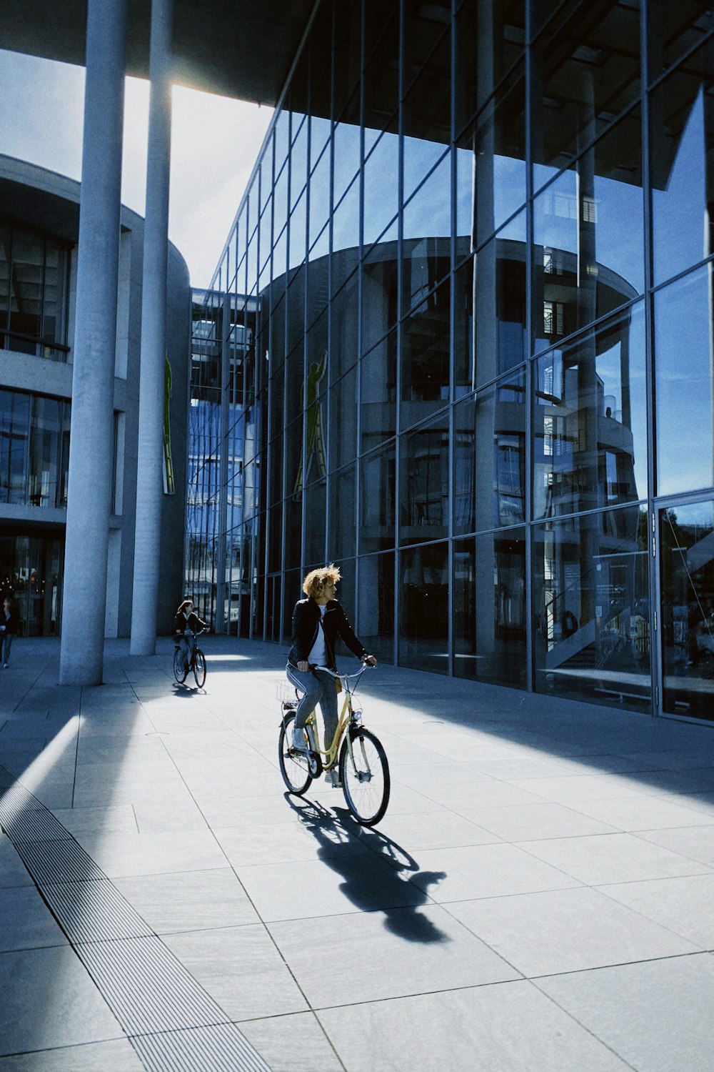 a person riding a bike in front of a building