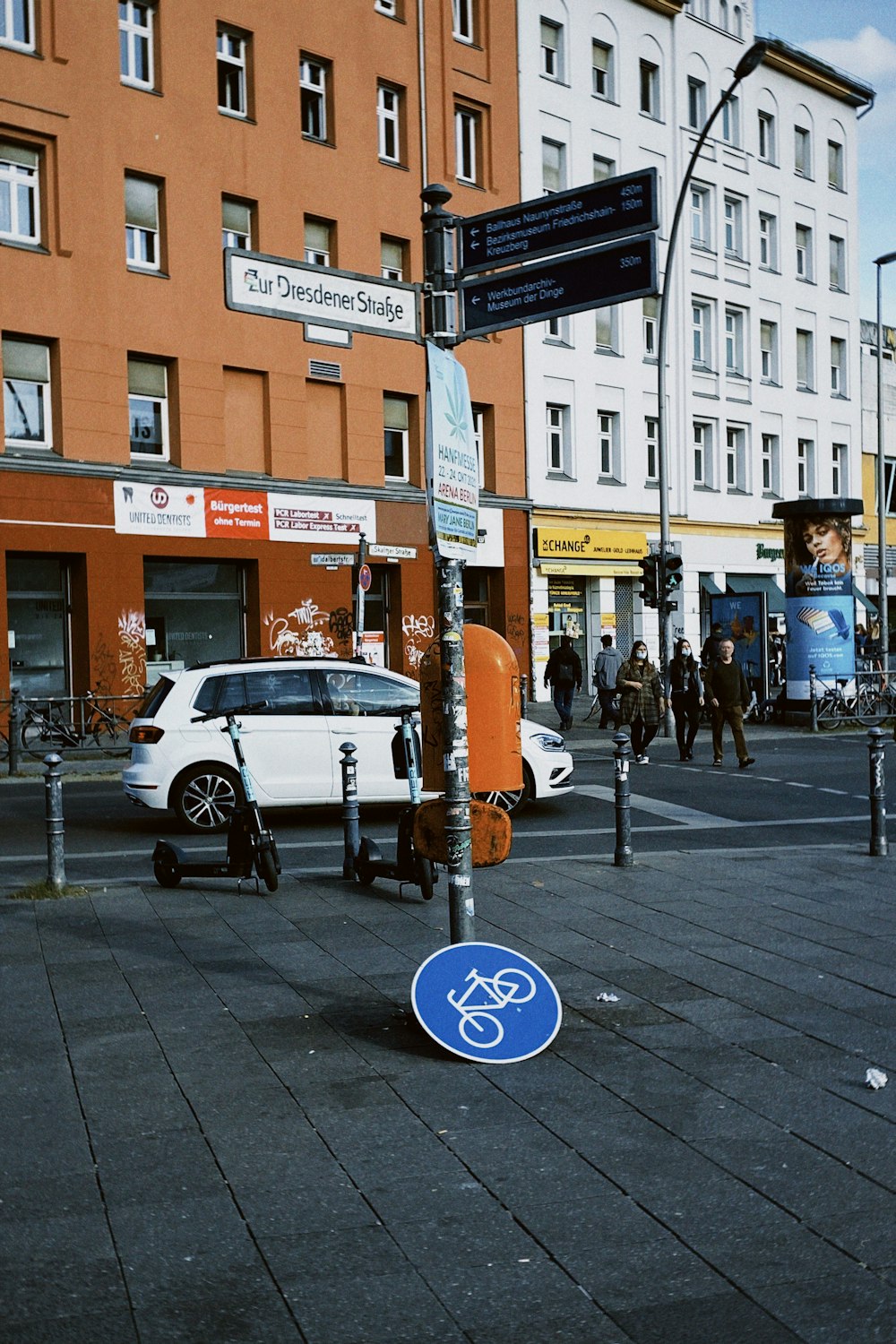 a blue street sign sitting on the side of a road