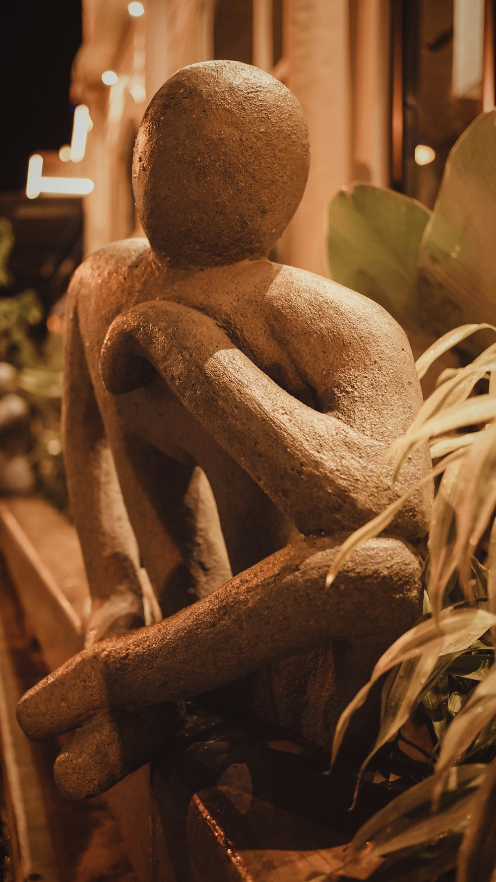 a statue of a person sitting on a bench