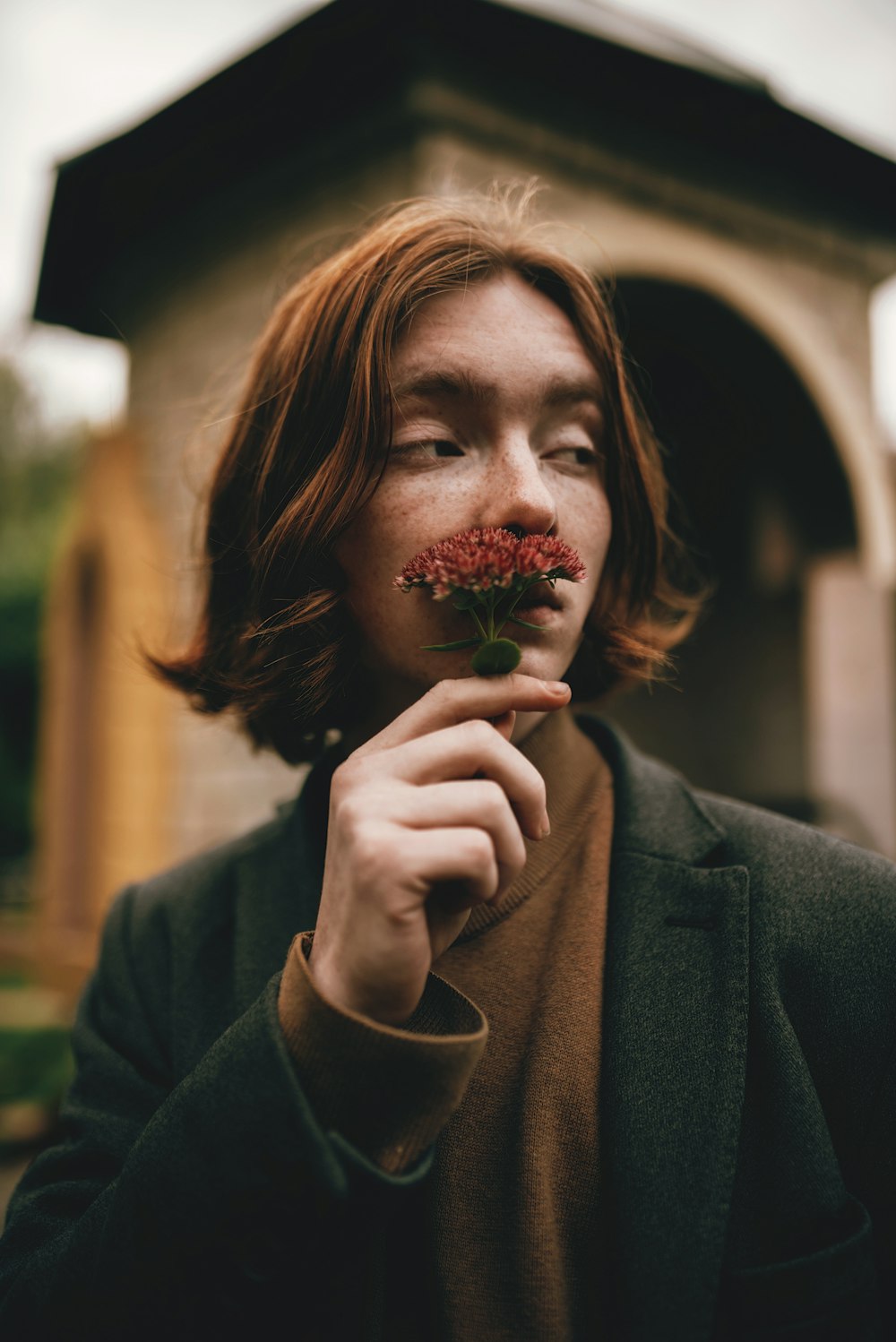 a man with a flower in his mouth