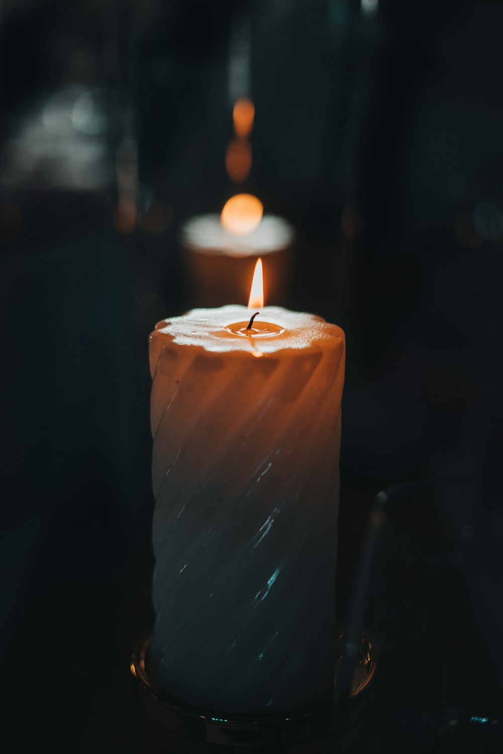 a lit candle sitting on top of a table