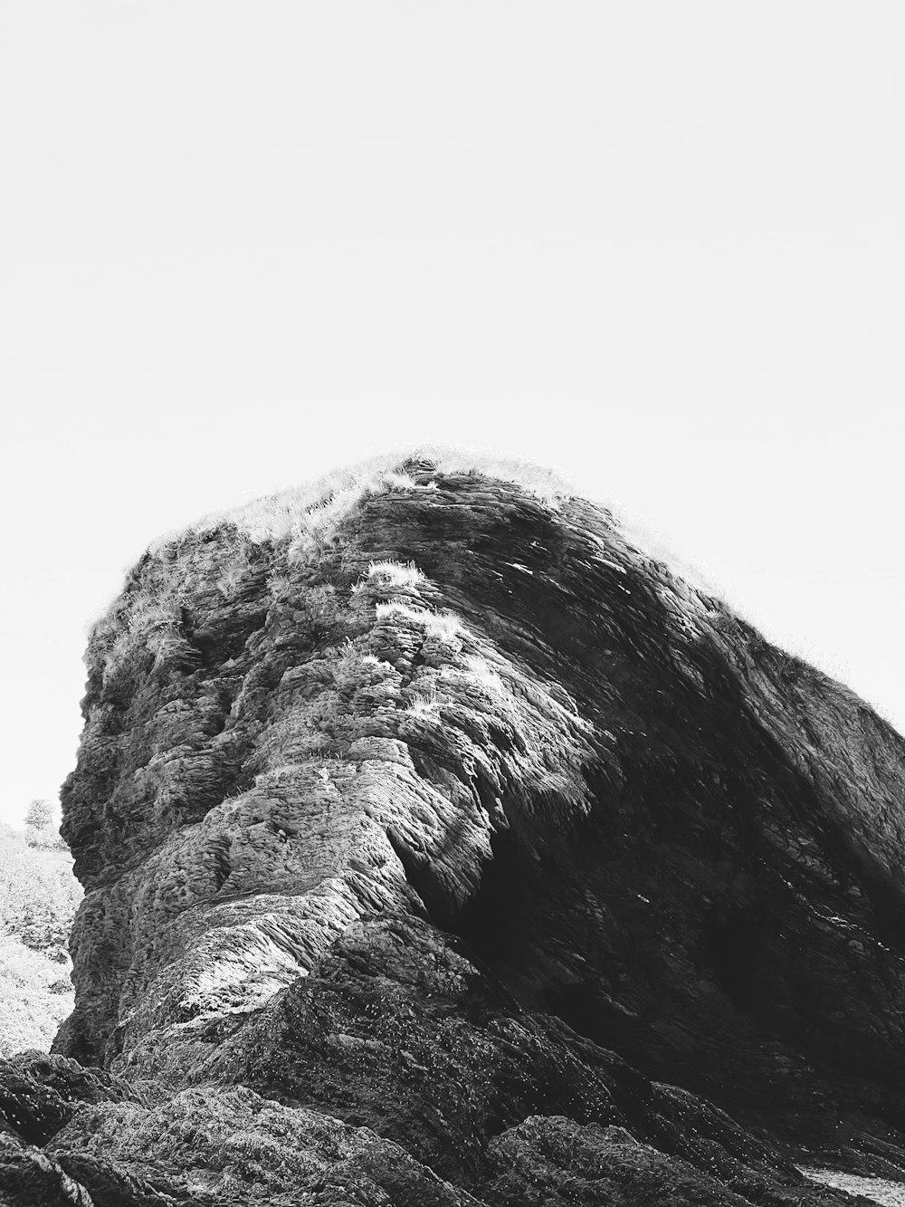 a black and white photo of a large rock