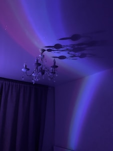 A beautiful chandelier hanging elegantly against a blue background.