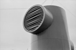 a black and white photo of a large metal object