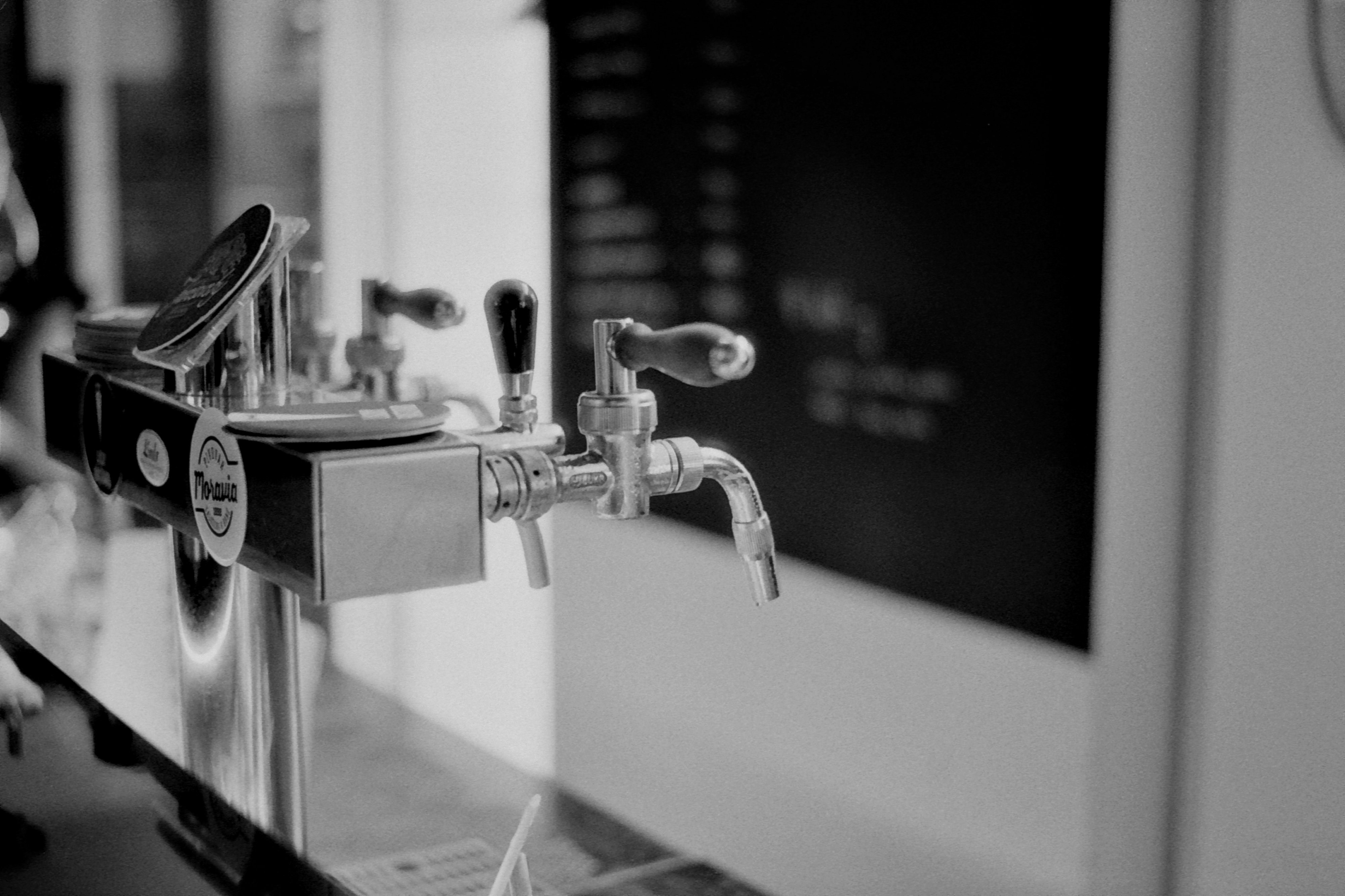 a black and white photo of a beer tap