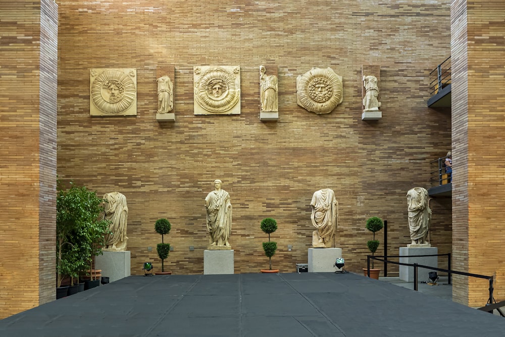 a group of statues sitting on top of a stage