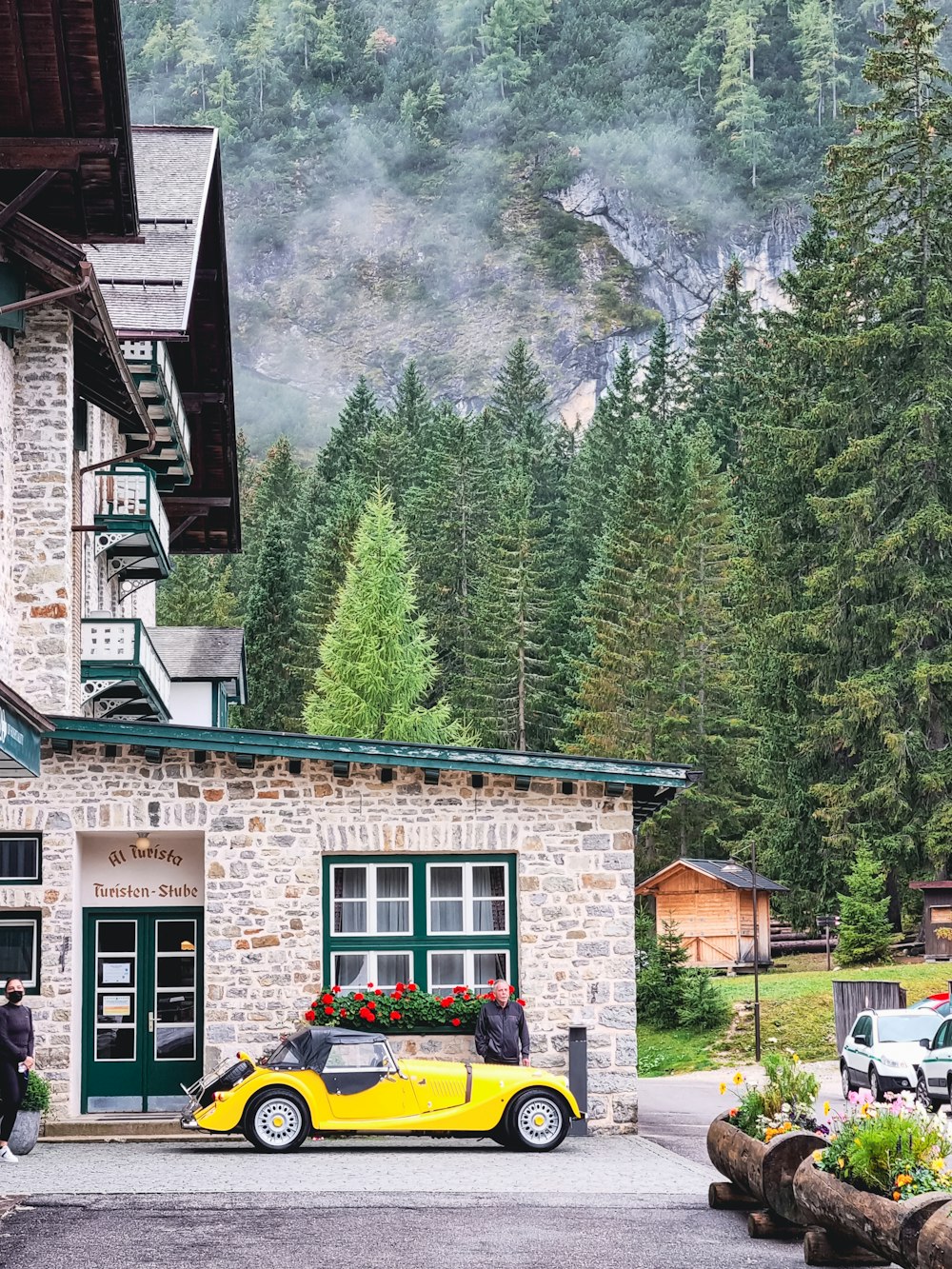 a yellow car parked in front of a building