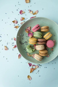 A colorful assortment of macarons arranged neatly on a pastel plate.