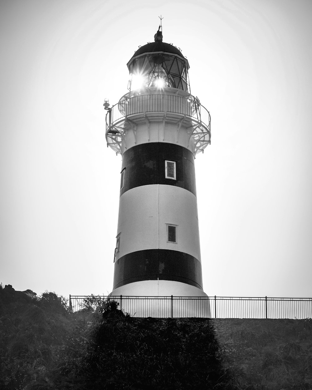 a black and white photo of a lighthouse