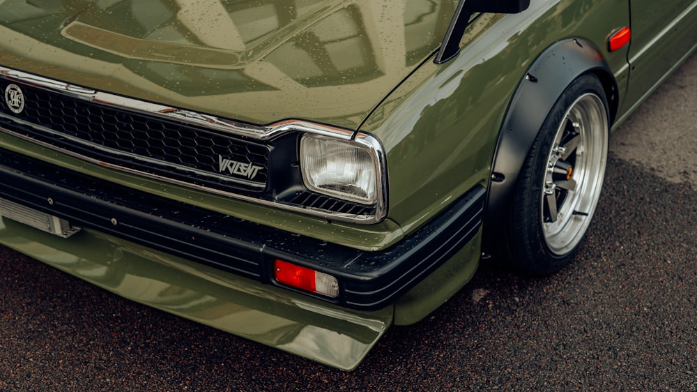 a green car parked on the side of the road