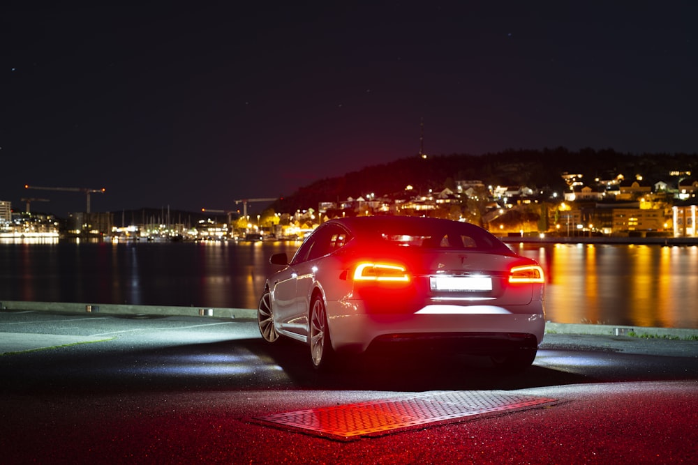 a car parked on the side of the road at night