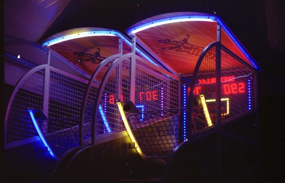 a couple of neon signs sitting on top of a set of stairs