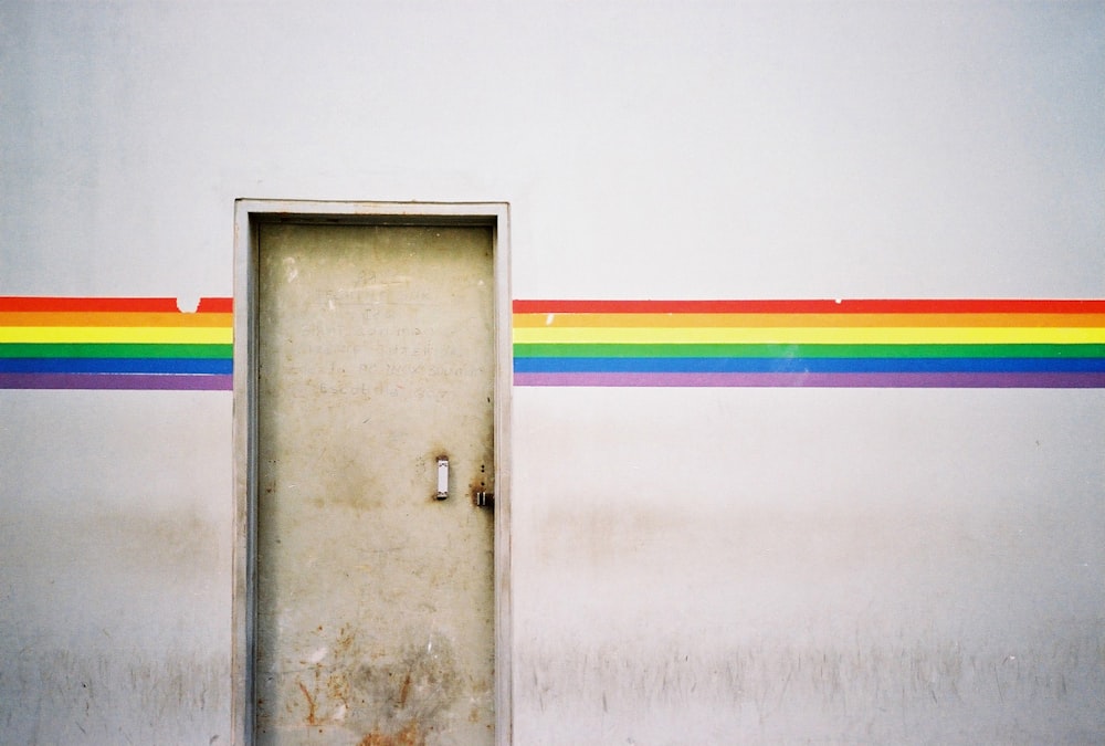 a door with a rainbow painted on the side of it