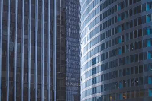 Sleek commercial office buildings with glass facades reflecting the skyline.