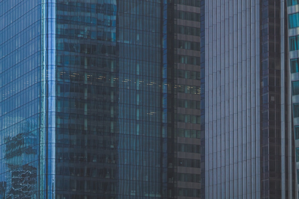 a plane flying in front of a very tall building