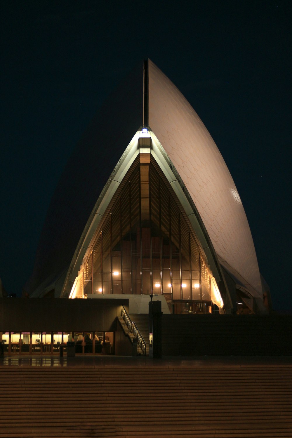 a large building lit up at night with stairs leading up to it