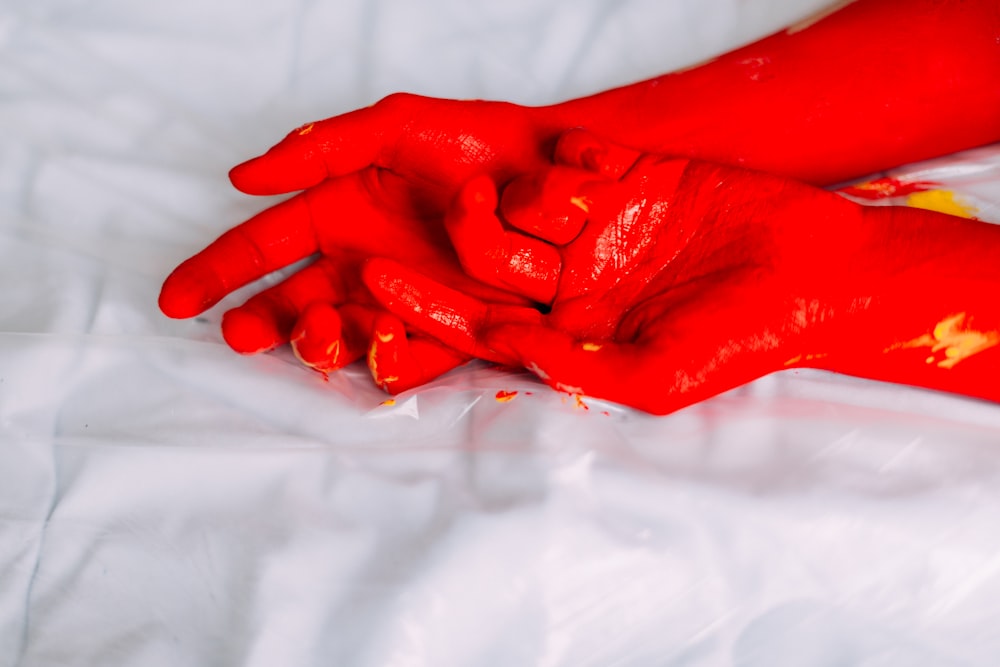 a person with red paint on their hands