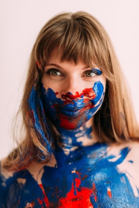 a woman with blue and red paint on her body