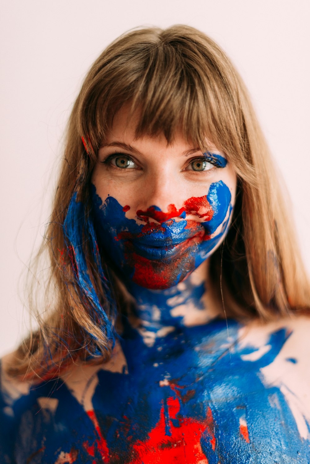 a woman with blue and red paint on her body