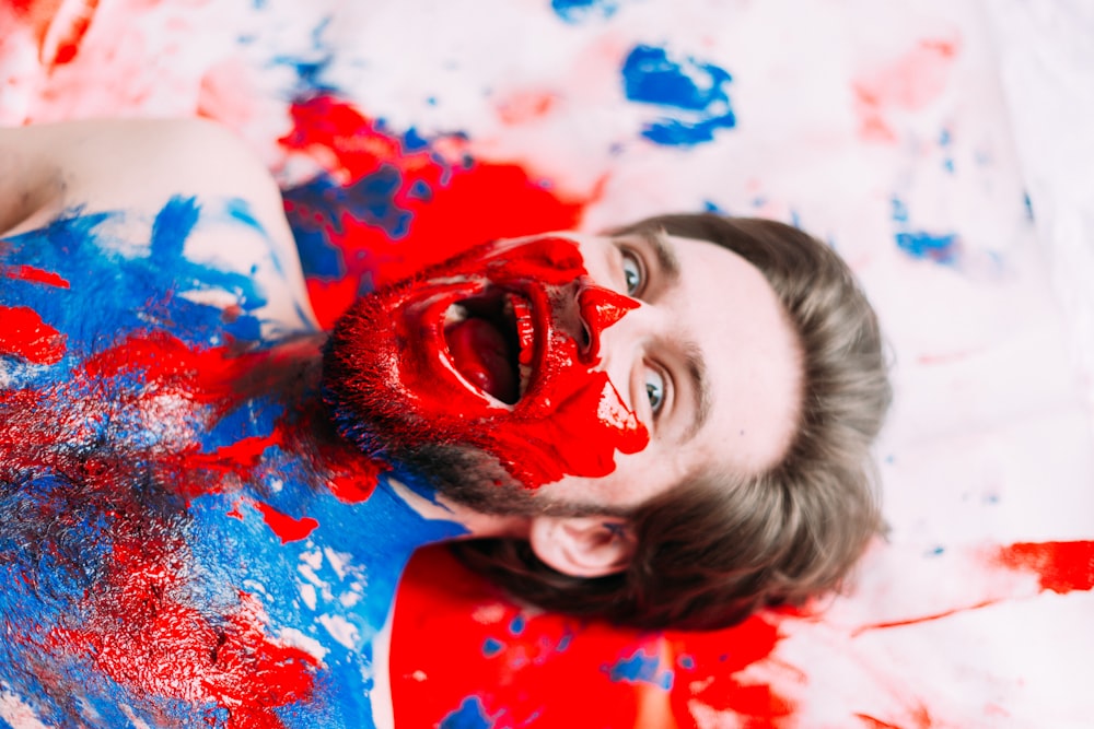 a man with red and blue paint on his face