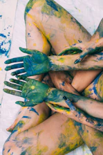 a woman covered in yellow and green paint