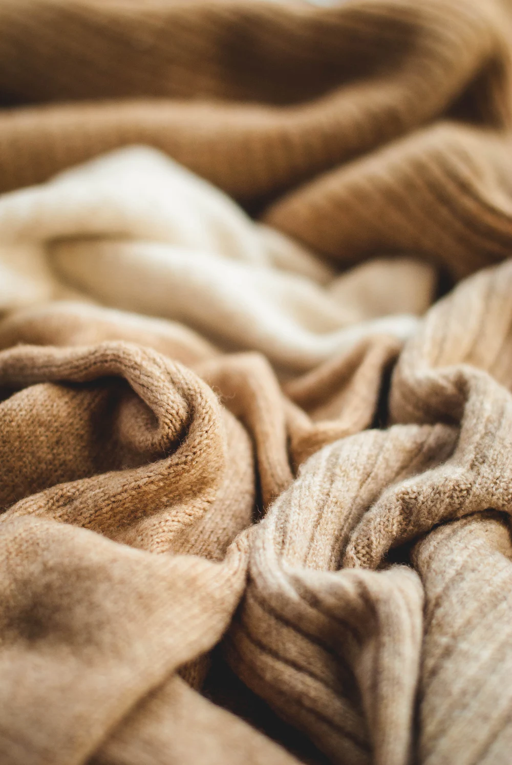 A folded wool blanket photographed close, the weave visible.