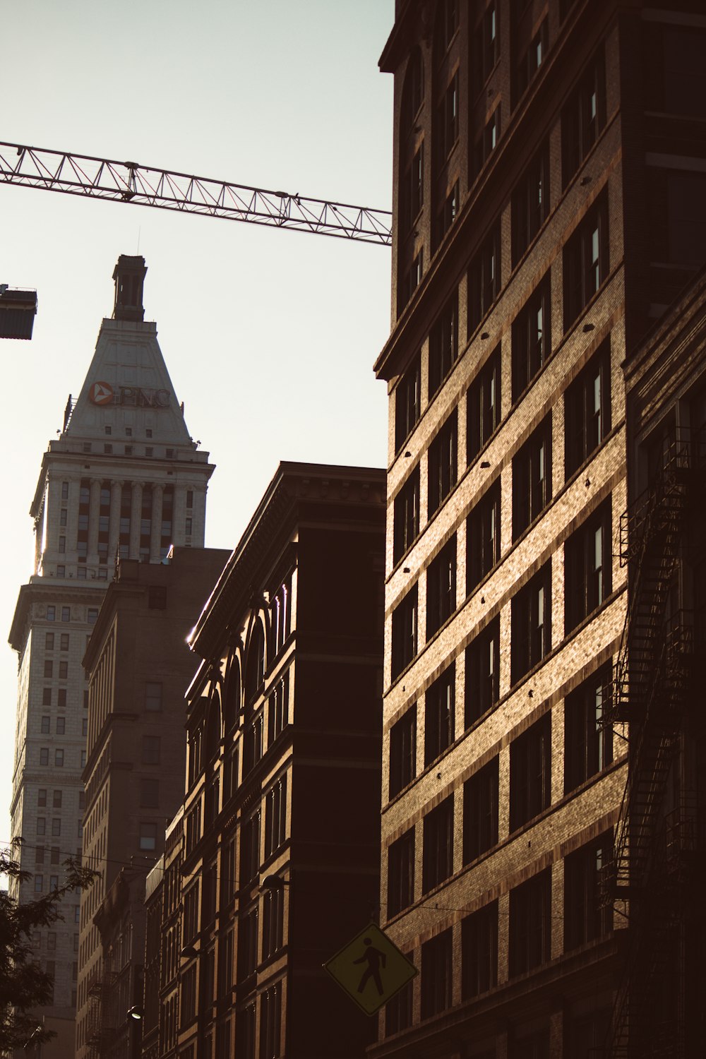 a tall building with a crane in the background