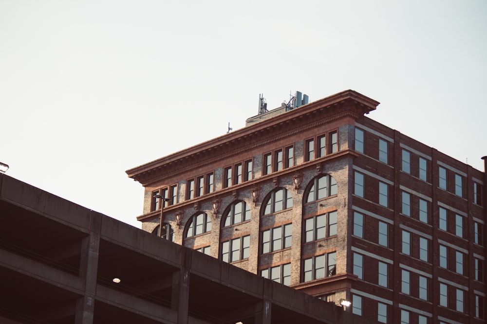 a tall brick building sitting next to a tall building