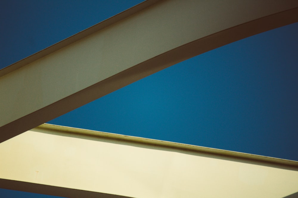 a close up of a metal structure with a blue sky in the background