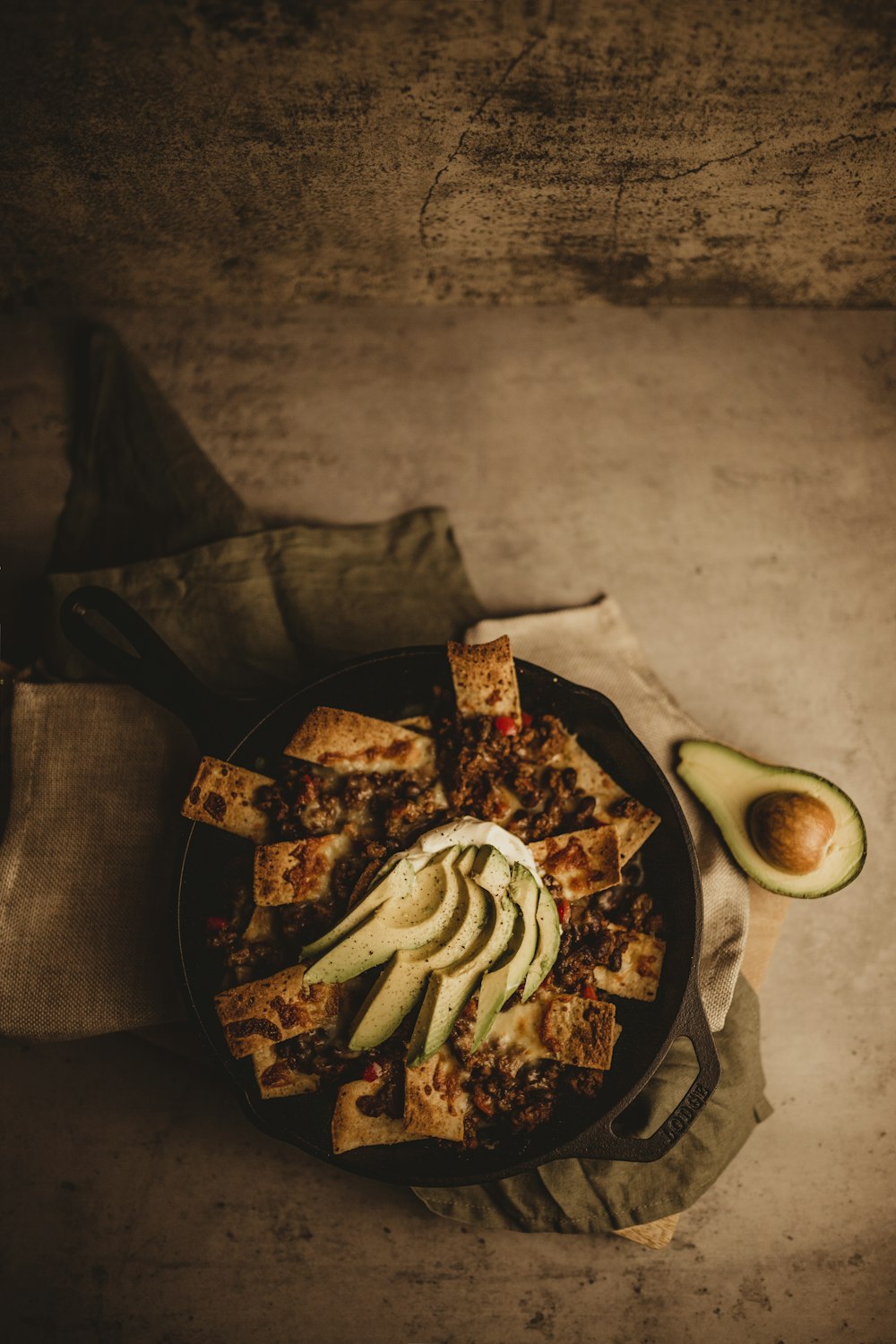 a plate of food with sliced avocado on it