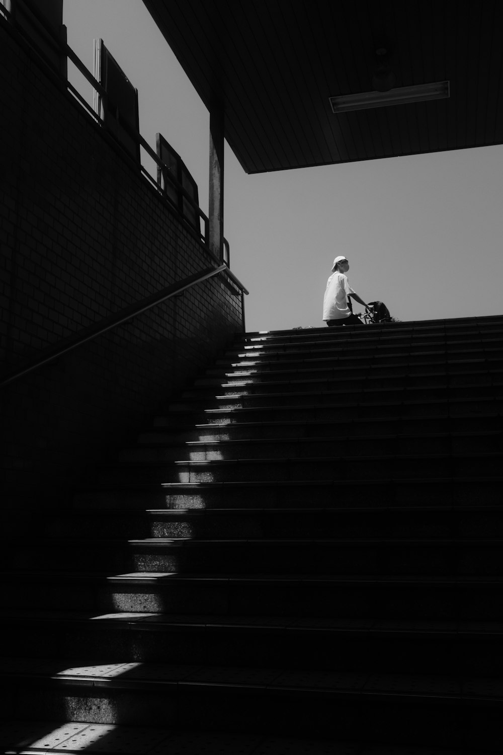 a person sitting on top of a set of stairs