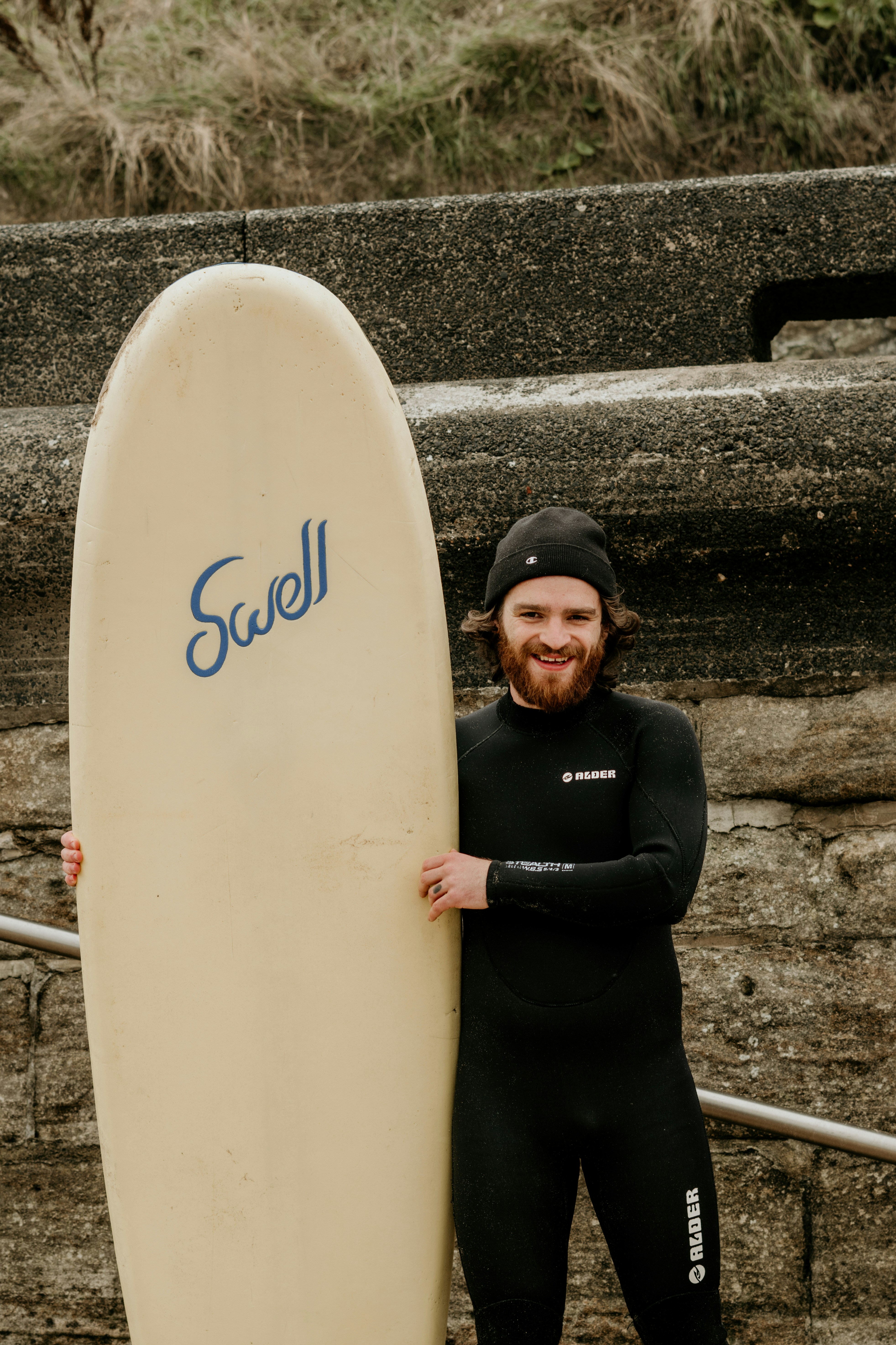 Un hombre sosteniendo una tabla de surf