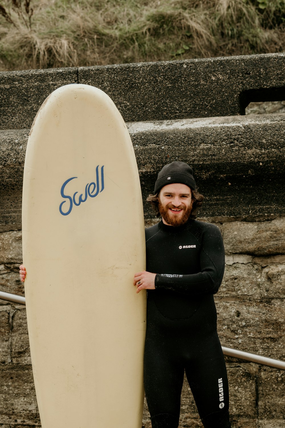 a man holding a surfboard