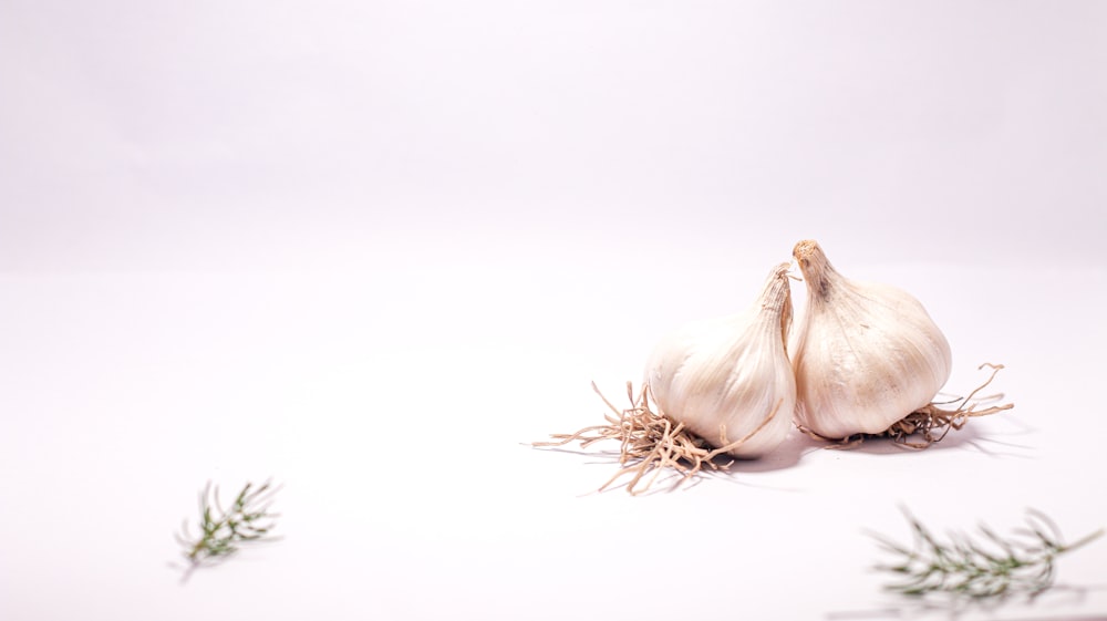 a close up of a garlic on a white surface